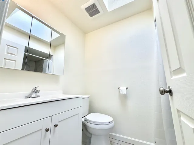 a bathroom with a sink a toilet and mirror