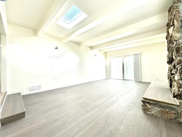 a view of a room with wooden floor