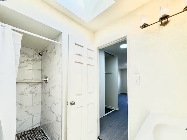a bathroom with a shower and a sink