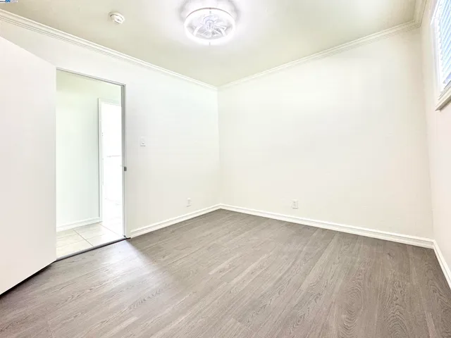 an empty room with wooden floor