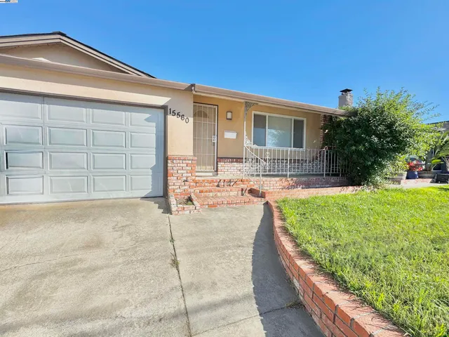 a view of a balcony with a floor to ceiling window and wooden fence