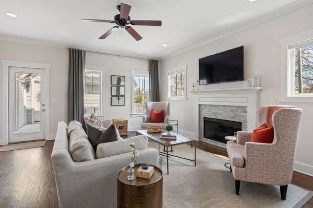 a living room with furniture fireplace and a flat screen tv