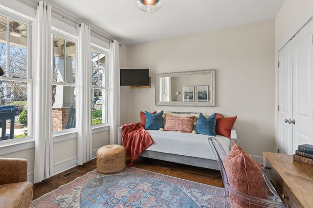 a bedroom with a bed and glass window
