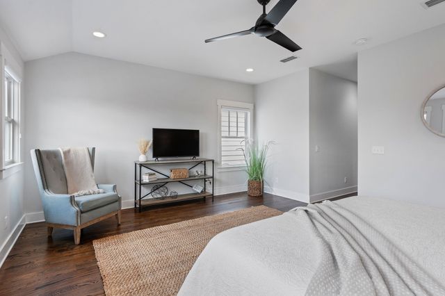 a bedroom with furniture and a flat screen tv