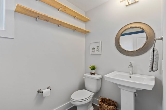 a bathroom with a sink mirror vanity and toilet
