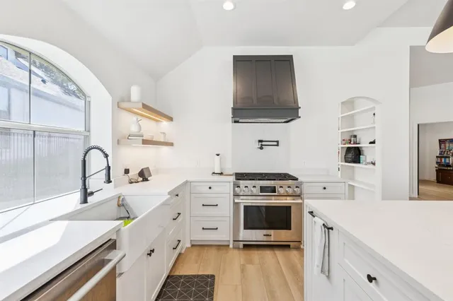 a kitchen with cabinets and window
