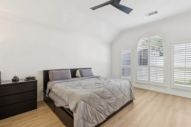 a spacious bedroom with a bed and a table