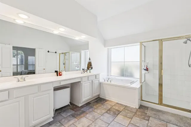 a spacious bedroom with a bed and wooden floor