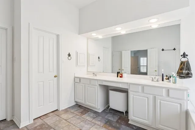 a bathroom with a tub sink and mirror