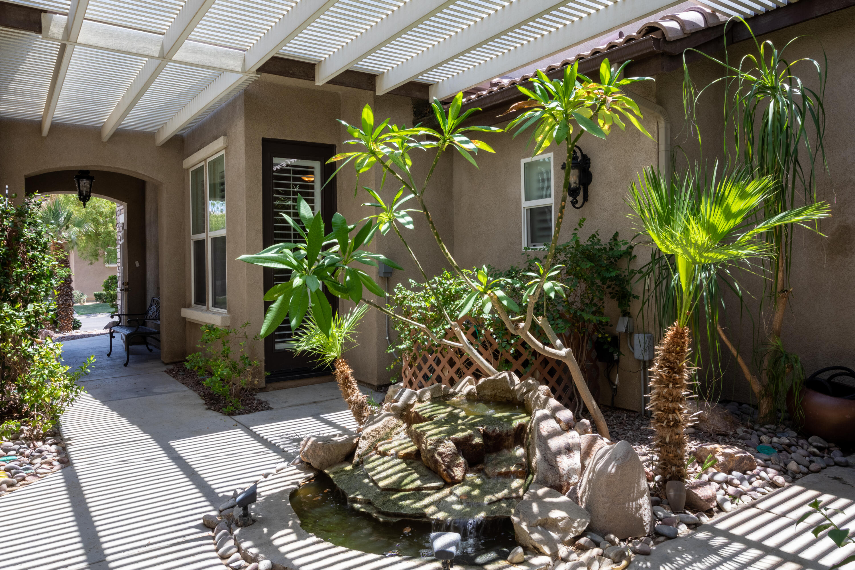 49475 Redford Way Indio, CA 92201 - Photo 13 of 45 a potted plant sitting in front of a house