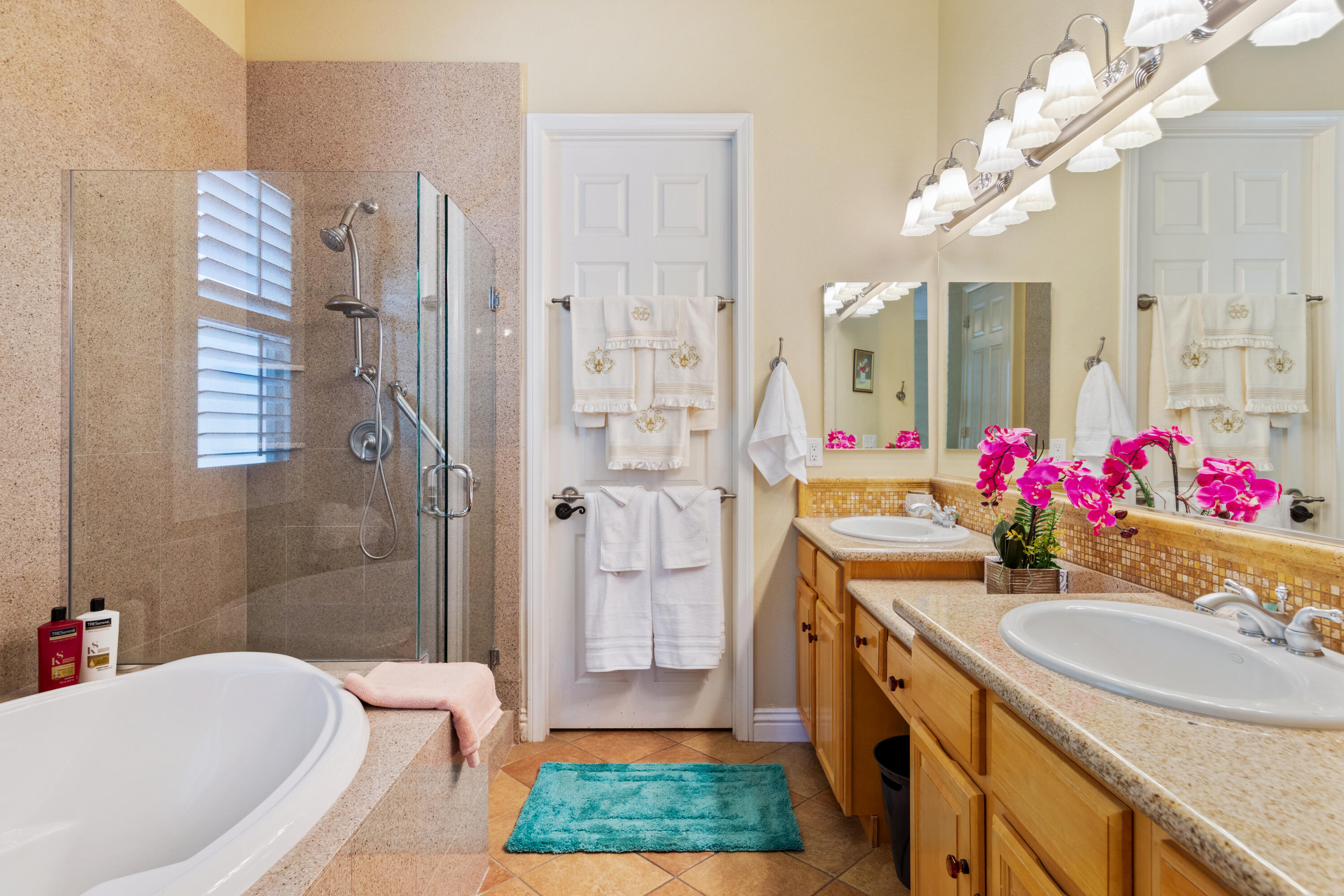 49475 Redford Way Indio, CA 92201 - Photo 19 of 45 a bathroom with a tub sink vanity granite and a shower