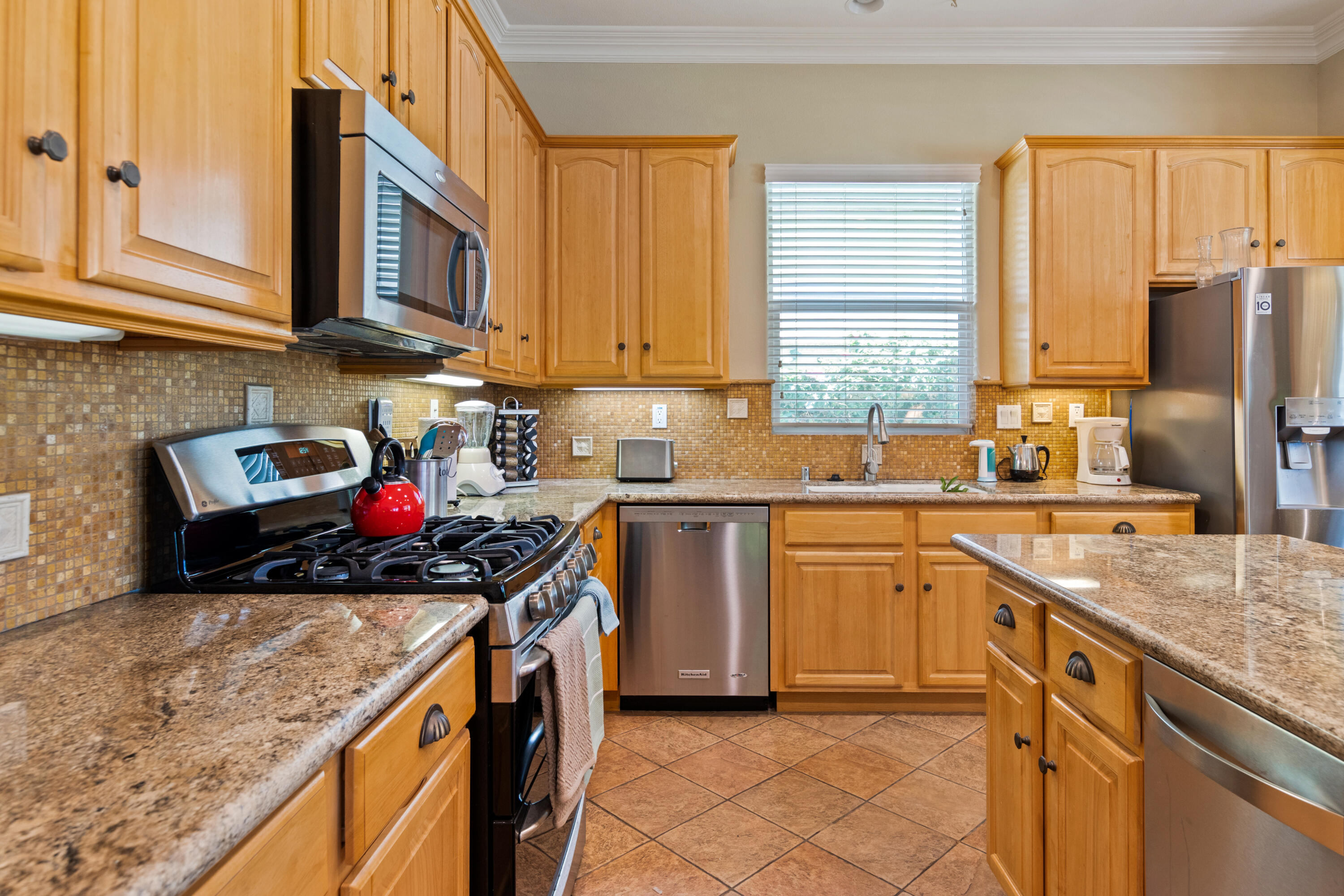 49475 Redford Way Indio, CA 92201 - Photo 24 of 45 a kitchen with stainless steel appliances granite countertop a sink stove and cabinets