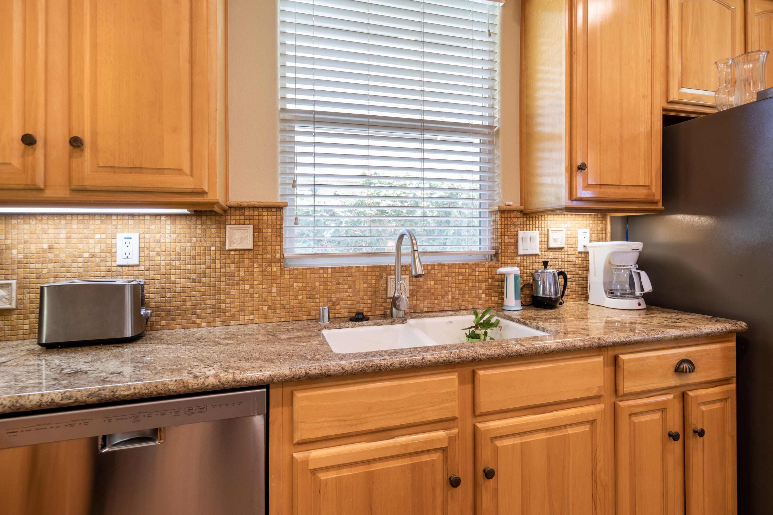 49475 Redford Way Indio, CA 92201 - Photo 25 of 45 a kitchen with stainless steel appliances granite countertop a sink a cabinets and a window