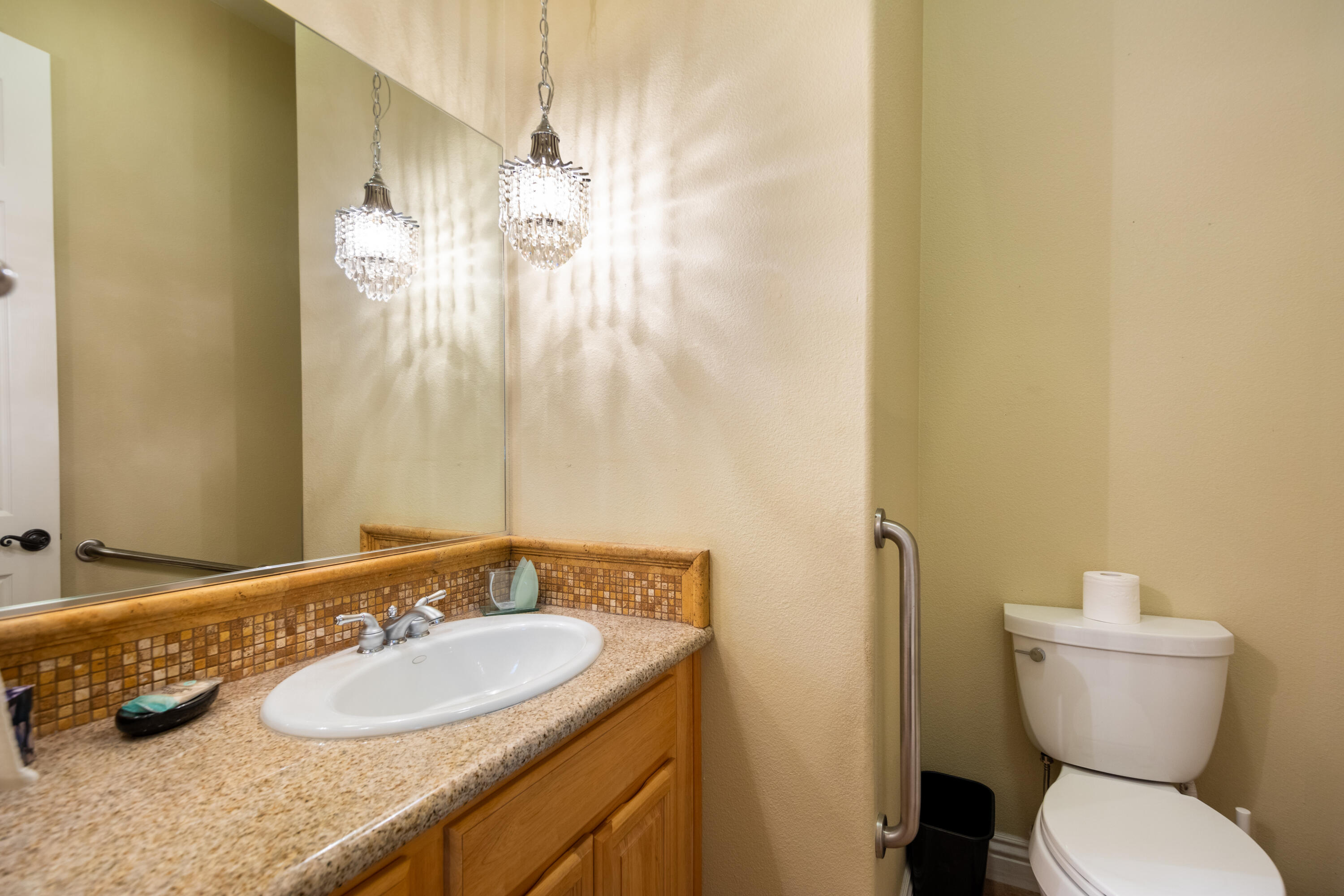 49475 Redford Way Indio, CA 92201 - Photo 36 of 45 a bathroom with a granite countertop sink and a mirror