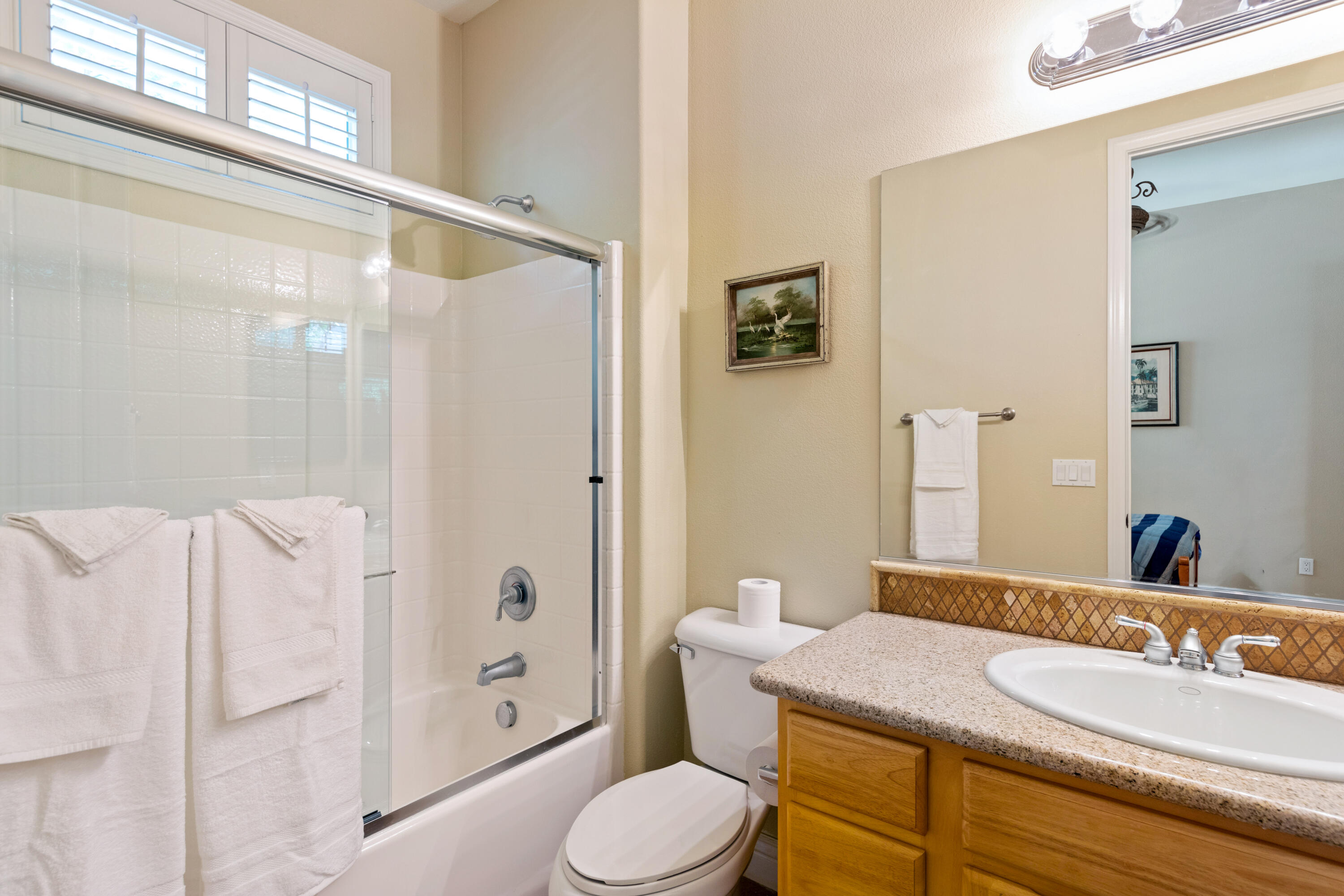 49475 Redford Way Indio, CA 92201 - Photo 37 of 45 a bathroom with a granite countertop sink toilet a mirror a shower and a bathtub