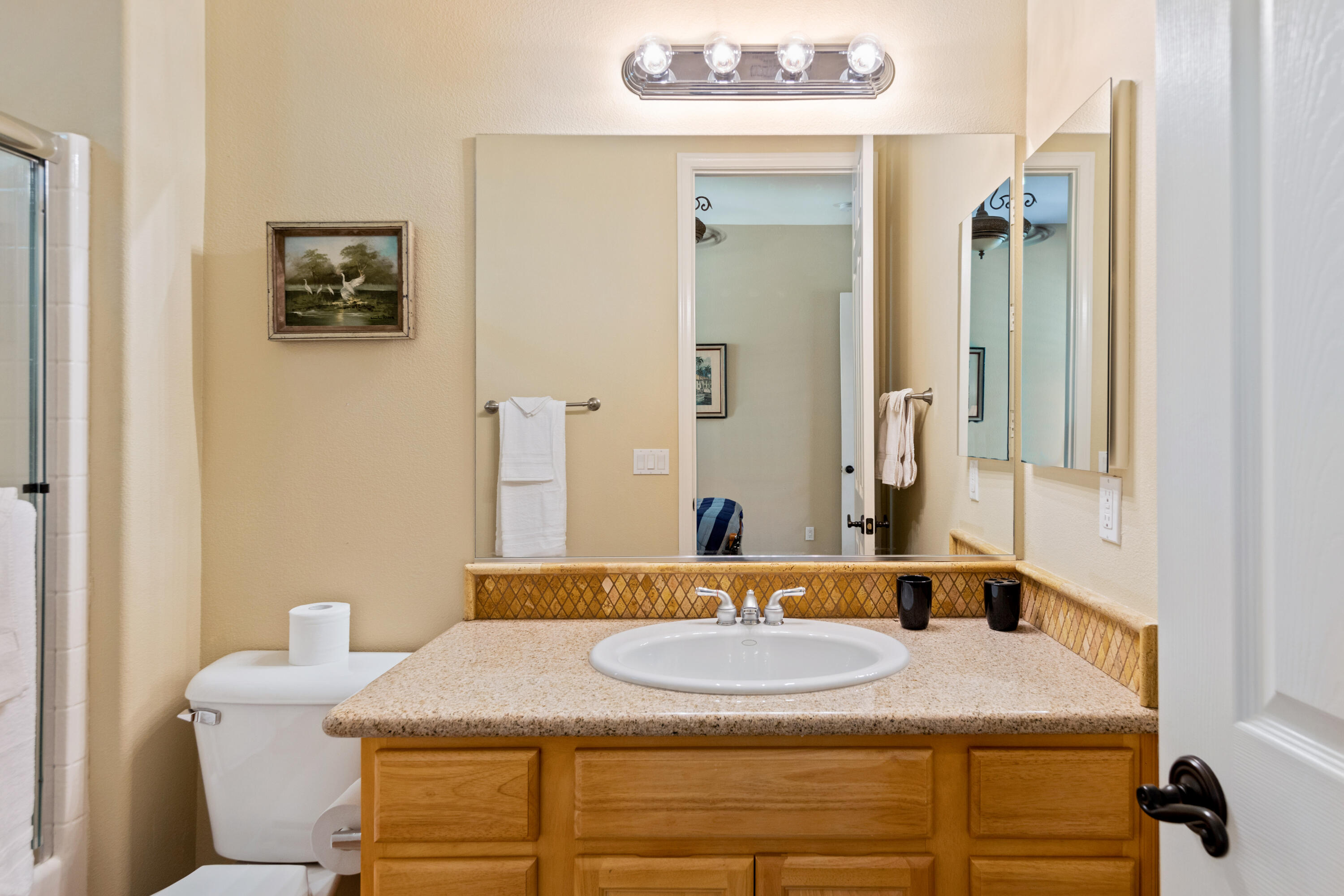 49475 Redford Way Indio, CA 92201 - Photo 38 of 45 a bathroom with a granite countertop sink and a mirror