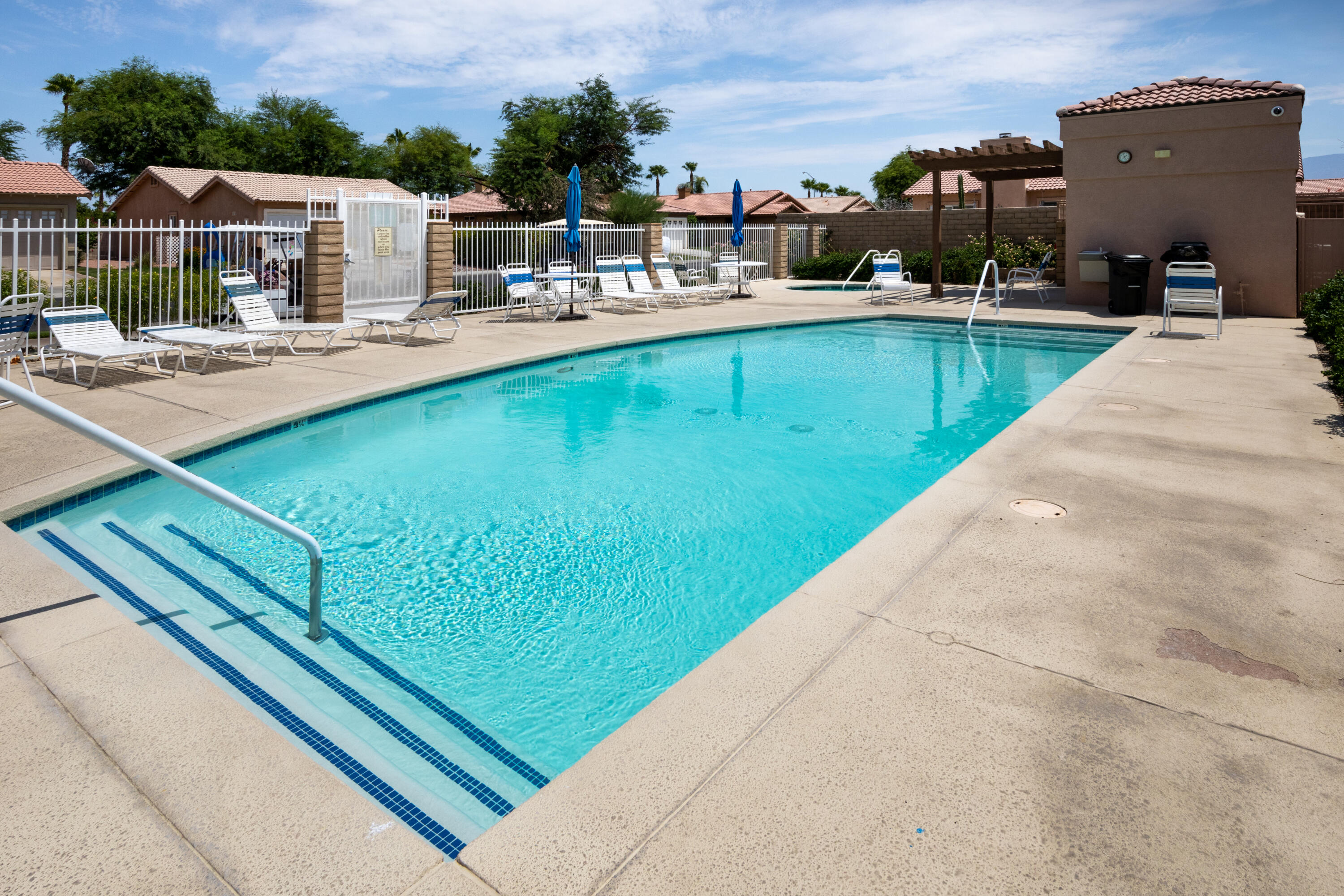 49475 Redford Way Indio, CA 92201 - Photo 8 of 45 a view of a swimming pool with a lounge chairs
