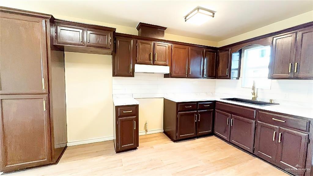 204 South Mcdaniel Street Edcouch, TX 78538 - Photo 3 of 9 a kitchen with stainless steel appliances granite countertop a refrigerator and a sink