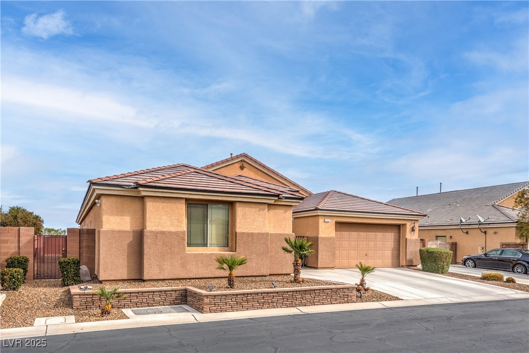 172 Turtle Ridge Avenue Las Vegas, NV 89183 - Photo 38 of 38 View of front of property featuring a tiled roof, driveway, stucco siding, and fence