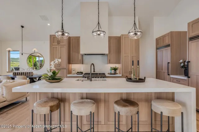 a kitchen with kitchen island a counter top space appliances and cabinets