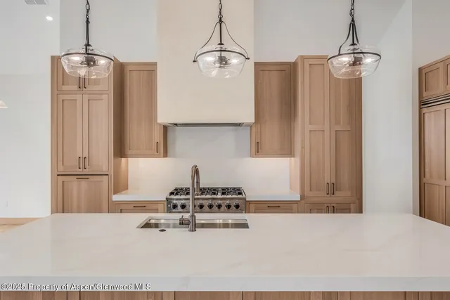 a view of a kitchen counter space and a sink