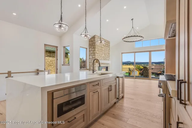 a kitchen with stainless steel appliances a stove a sink and a refrigerator