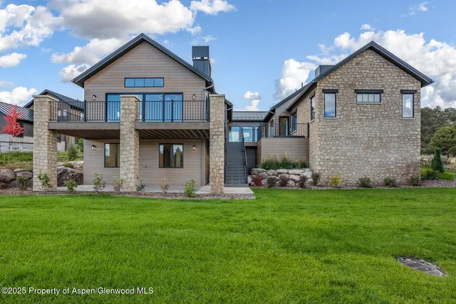 a view of a house with a yard and sitting area