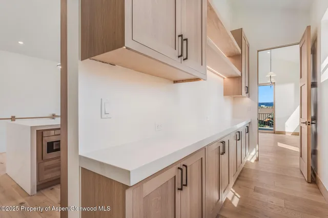 a bedroom with a bed and painting on the wall