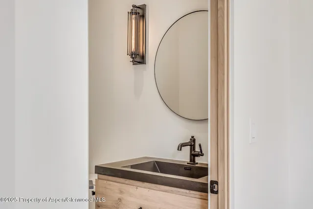 a bathroom with a sink and mirror
