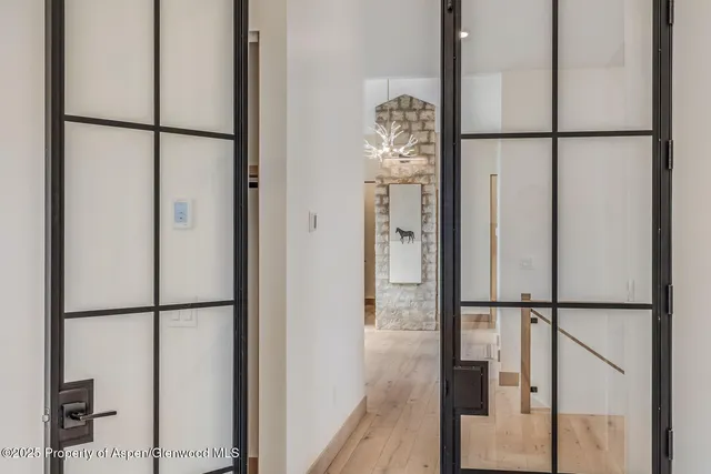 a view of empty room with wooden floor and window