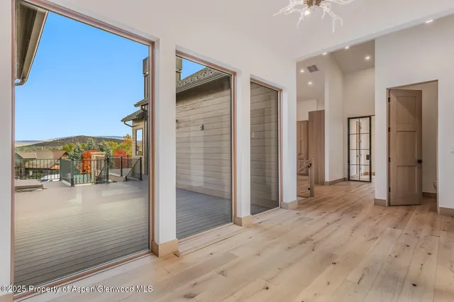 a view of an empty room with window and fireplace