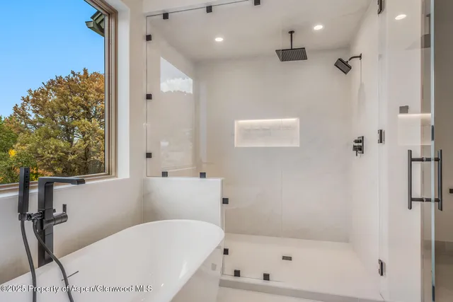 a bathroom with a double vanity sink mirror and shower