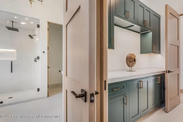 a view of a small space with wooden floor and a window