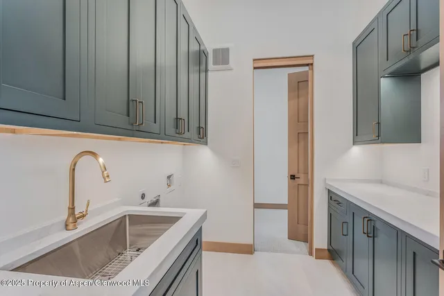 a view of an empty room with cabinet and a window