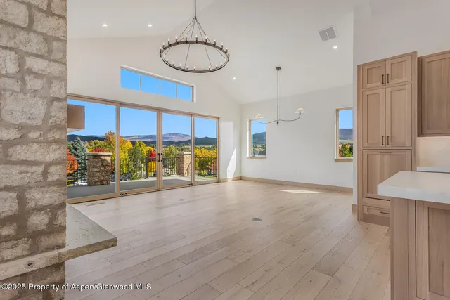 a living room with furniture a fireplace and a large window