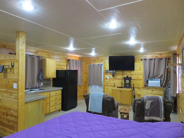 a view of a patio with table and chairs under an umbrella