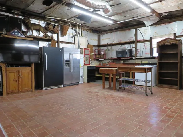 a view of a garage with wooden table and chairs