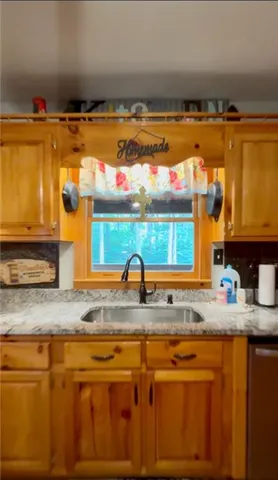 a kitchen with stainless steel appliances granite countertop a sink and a granite countertops