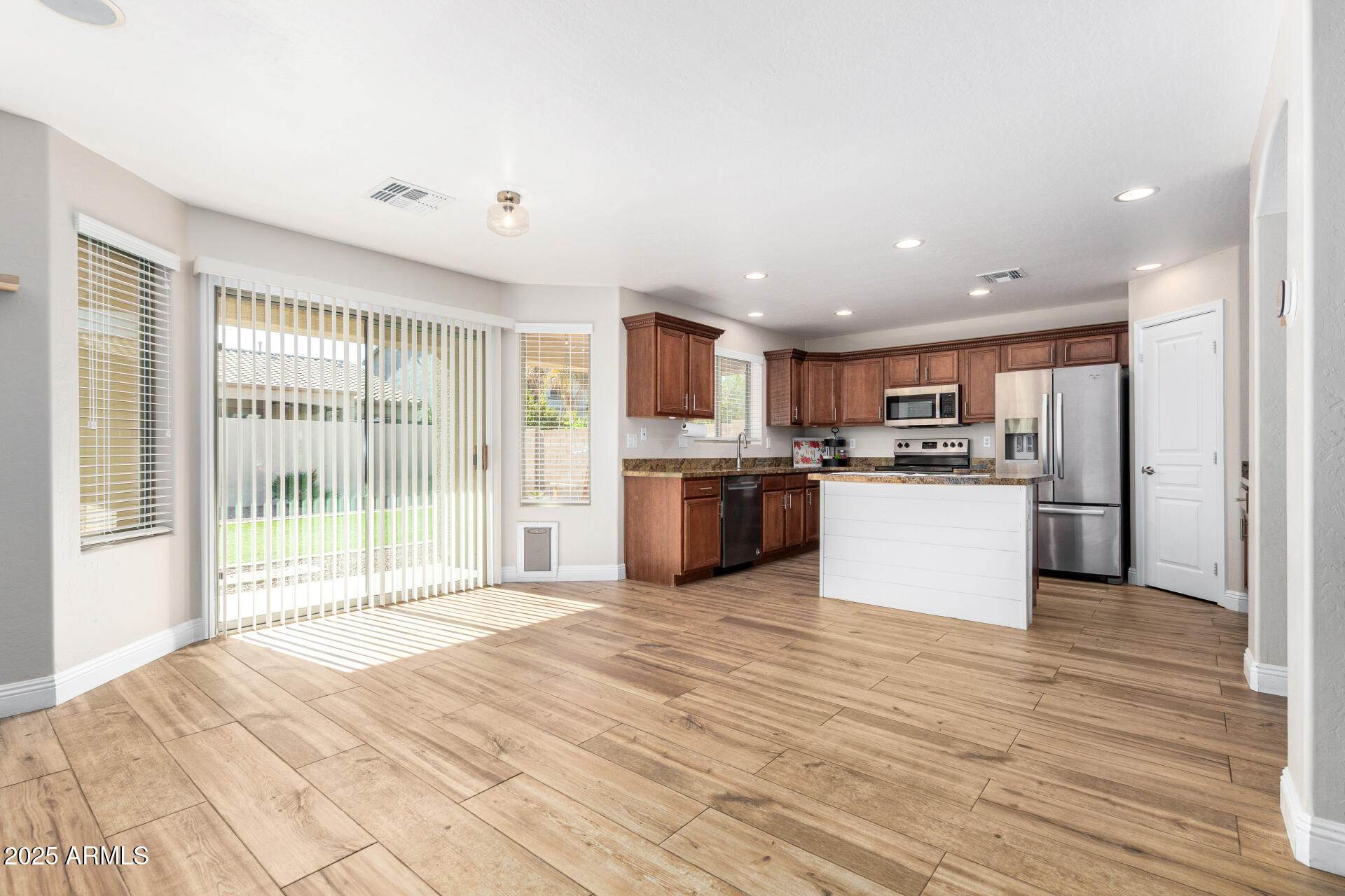 3563 East Blue Ridge Way Gilbert, AZ 85298 - Photo 13 of 48 a large kitchen with a stove top oven a sink and cabinets