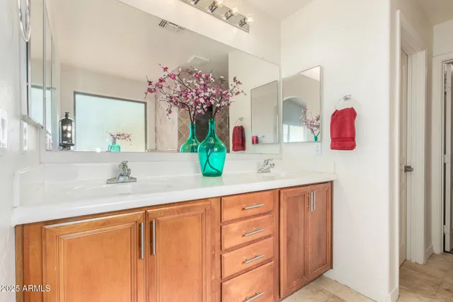 a bathroom with a sink vanity and mirror