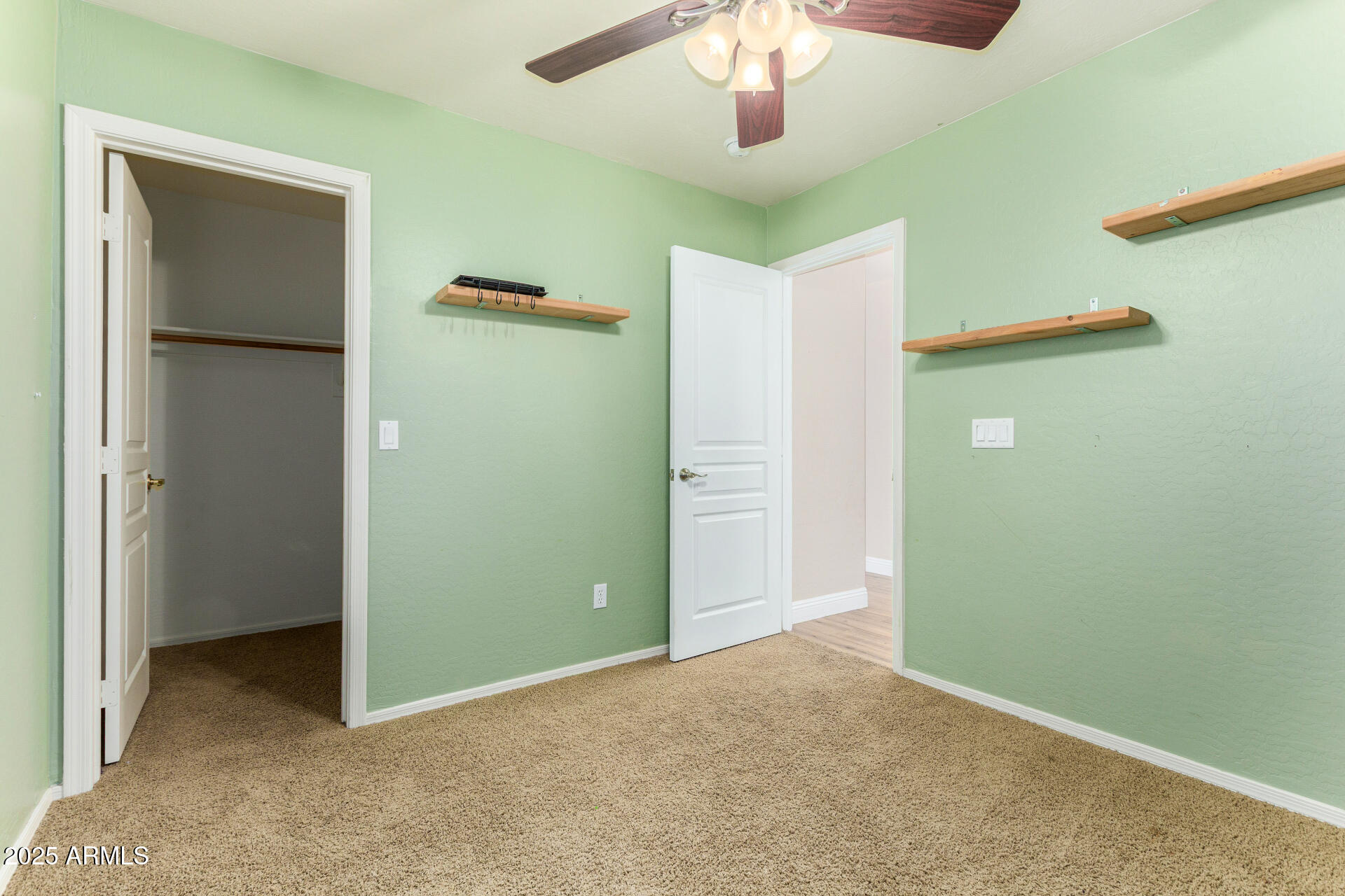 3563 East Blue Ridge Way Gilbert, AZ 85298 - Photo 27 of 48 an empty room with closet and a chandelier fan