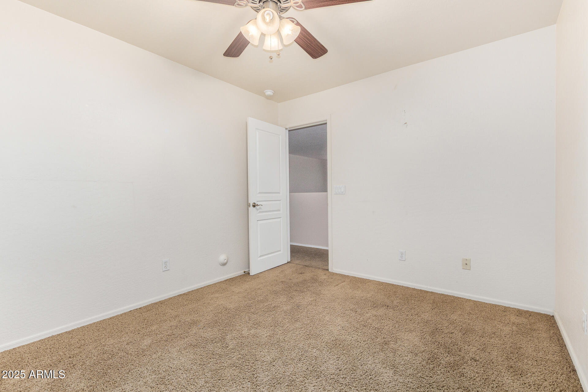 3563 East Blue Ridge Way Gilbert, AZ 85298 - Photo 33 of 48 an empty room with a chandelier fan and kitchen view