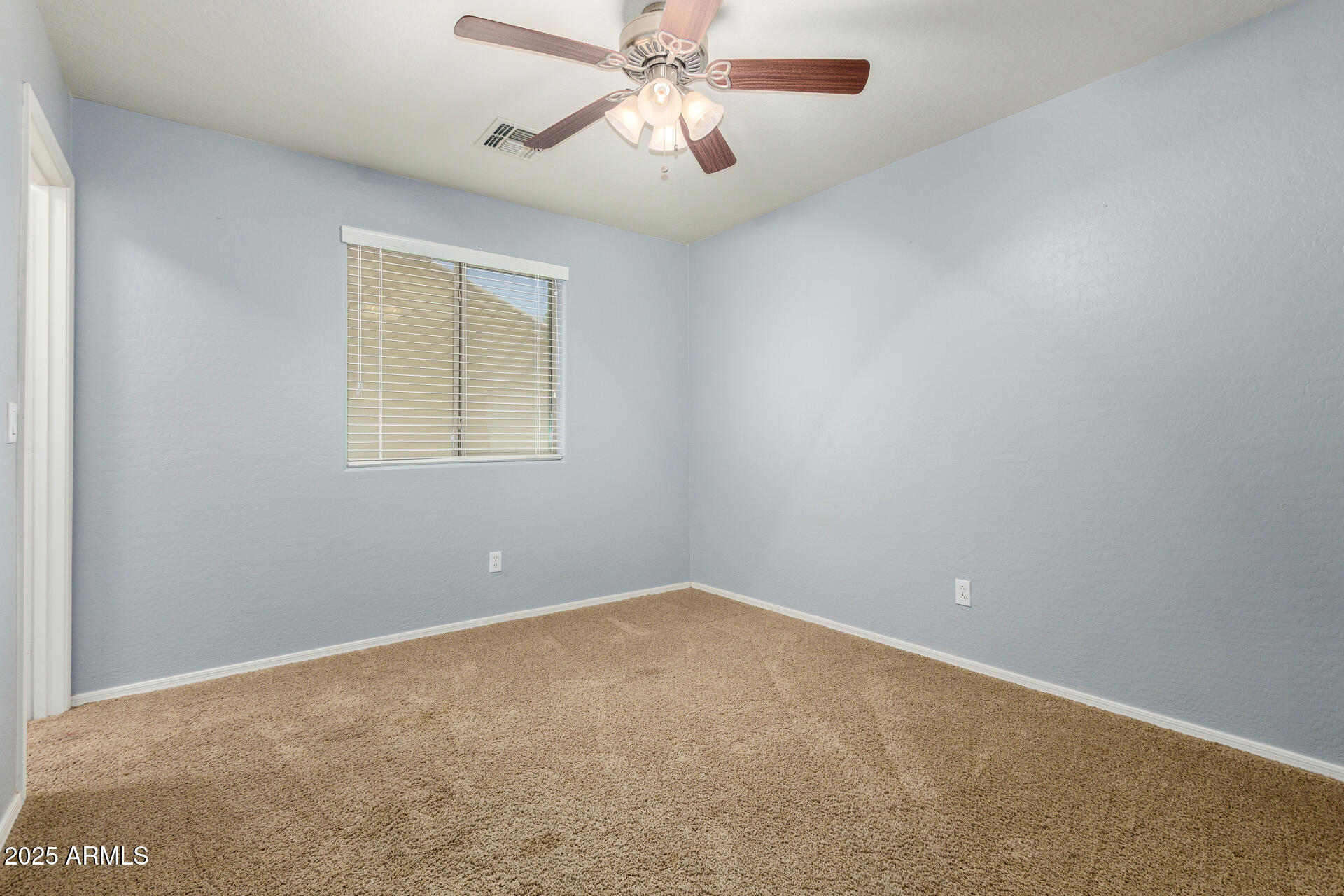 3563 East Blue Ridge Way Gilbert, AZ 85298 - Photo 35 of 48 an empty room with a window and a fan