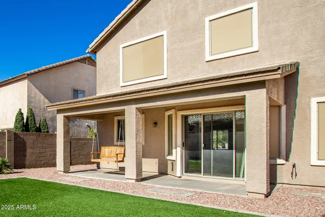 a view of a house with a yard and sitting area