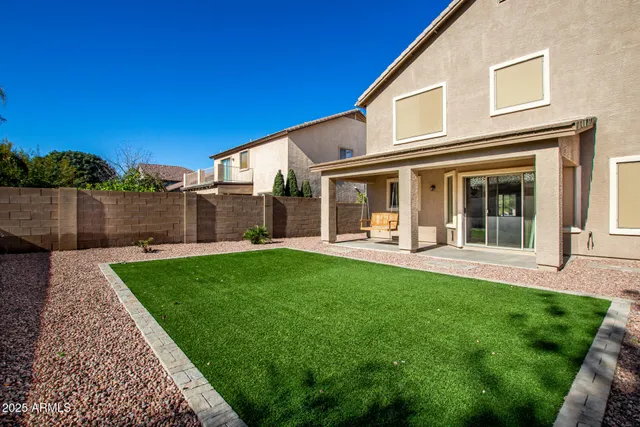 a view of a house with backyard porch and garden