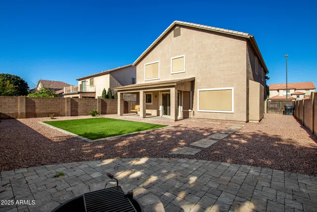 a view of a house with a backyard