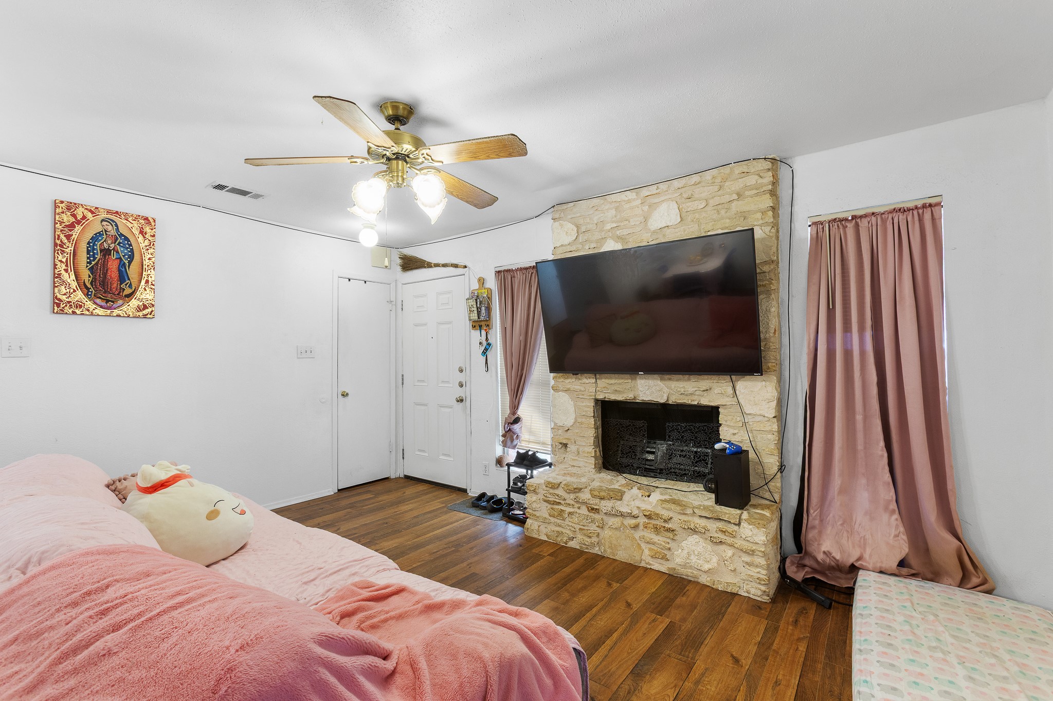 606 Misty Morning Way, Unit A AND B Round Rock, TX 78664 - Photo 12 of 22 Living area with dark wood-style floors, a ceiling fan, and a fireplace