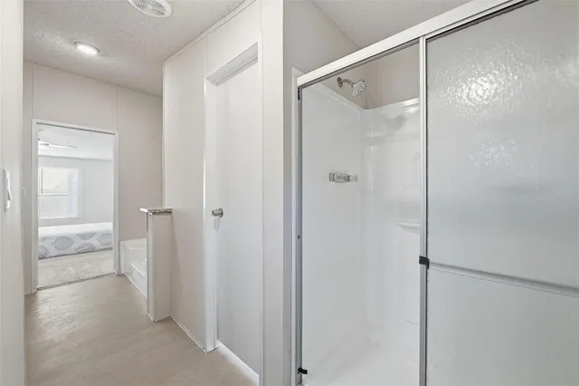 a bathroom with a glass shower door