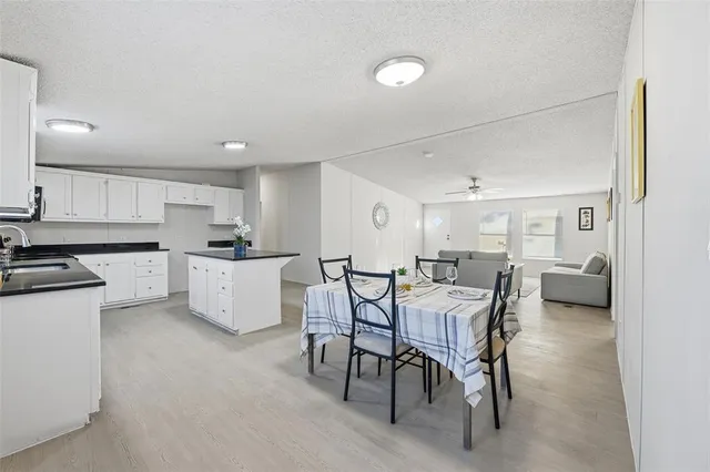 a view of a dining room with furniture and chandelier