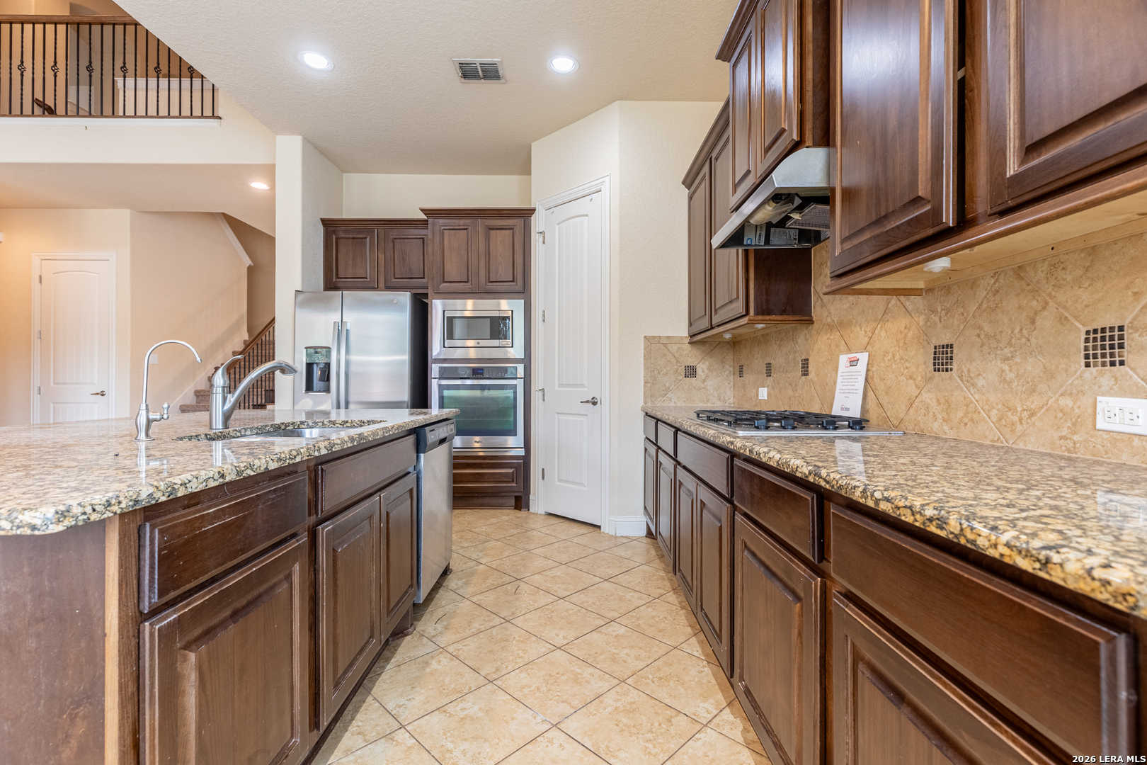 8103 Mystic Chase Boerne, TX 78015 - Photo 16 of 49 a large kitchen with stainless steel appliances granite countertop a sink and stove
